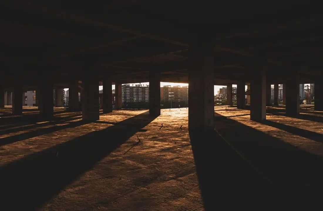 Concrete floor with long shadows from columns at sunset