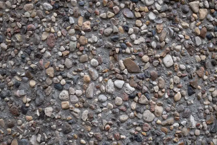 Close-up of concrete with rounded river stones showing through the surface