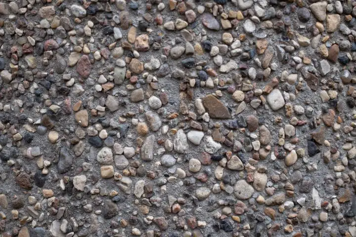 Close-up of concrete with rounded river stones showing through the surface